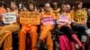 Activists from the antiwar group CodePink hold a silent protest aimed at the Senate Armed Services Committee during a hearing in Washington on the fate of the Guantanamo Bay detention center, Feb. 5, 2015.