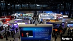 FILE - China's President Xi Jinping is shown on a screen in front of logos of China's leading internet companies during the World Internet Conference in Wuzhen town of Jiaxing, Zhejiang province, China, Nov. 17, 2016.