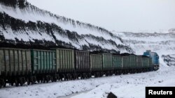 FILE - A train transports coal the Borodinsky opencast colliery, near the Siberian town of Borodino, some 152 km (94 miles) east of Krasnoyarsk, Nov. 15, 2012. 