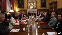 Britain's Prime Minister Theresa May, third left, sits with members of parliament during a meeting to tackle abuse following allegations of sexual harassment and abuse in British politics, at the Prime Minister's Office in the House of Commons, London, N