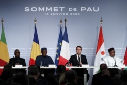 FILE - French President Emmanuel Macron, Mali's President Ibrahim Boubacar Keita, Niger President Mahamadou Issoufou, and Chad's President Idriss Deby, deliver a news conference at the G5 Sahel summit in Pau, Jan. 13, 2020.