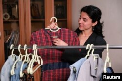 Fashion designer Jwana holds a piece of her own-designed upcycled clothes in Sulaimaniyah