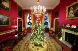 The Red Room of the White House is adorned with holiday decorations during a press preview in Washington, Nov. 30, 2020.