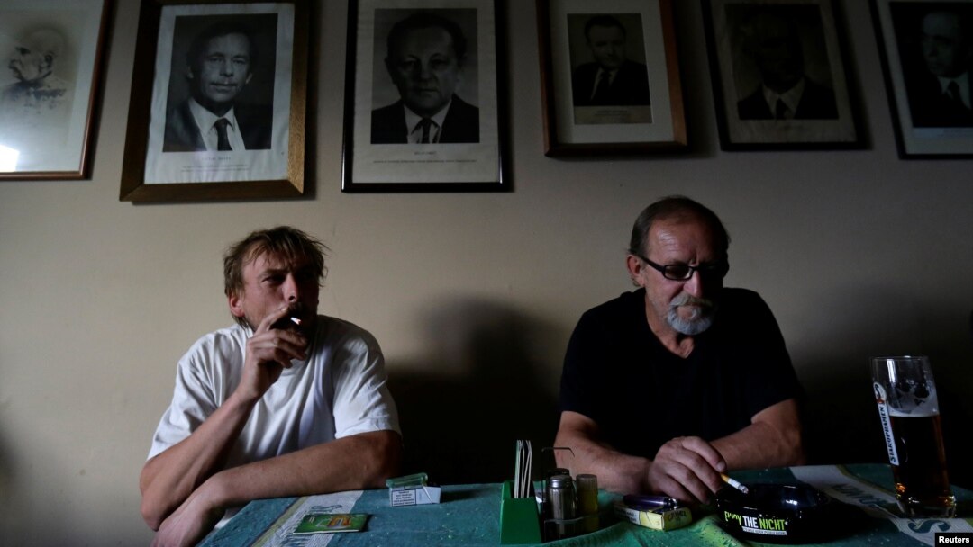 Men smoke cigarettes in a pub on a last day before a smoking ban comes into effect in Prague, Czech Republic, May 30, 2017.