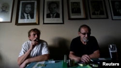 Men smoke cigarettes in a pub on a last day before a smoking ban comes into effect in Prague, Czech Republic, May 30, 2017.