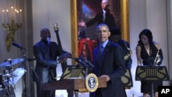 President Barack Obama walks onto the stage in the East Room of the White House in Washington at the beginning of the "In Performance at the White House" series, Oct. 14, 2015. 