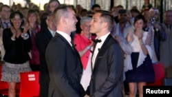 Vincent Autin (L) and Bruno Boileau hold hands after getting married at the town hall in Montpellier, France, May 29, 2013. 