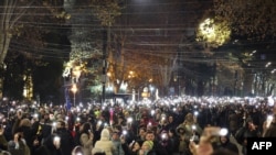 Anti-government demonstrators light up their mobile telephones as they protest against the Georgian government's postponement of European Union accession talks until 2028, outside the Parliament in Tbilisi, Dec. 12, 2024. 