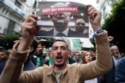 Algerian demonstrators take to the streets in the capital Algiers to reject the presidential elections, in Algiers, Algeria, Dec. 13, 2019.