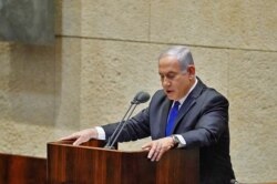 FILE - Israeli Prime Minister Benjamin Netanyahu speaks at the Knesset, Israel's parliament, ahead of the swearing-in ceremony of the new government, in Jerusalem, May 17, 2020, in this picture provided by the Israeli Knesset spokesperson office.