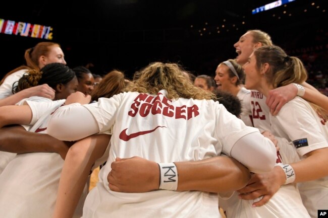 Stanford basketball players wear the letters KM on their wrists in honor of Katie Meyer, a soccer player who died from suicide earlier this year. (AP Photo/David Becker, File)