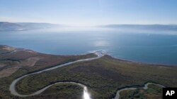 FILE - An aerial view shows the Jordan River estuary of the Sea of Galilee near the community settlement of Karkom, northern Israel, Dec. 8, 2017. 