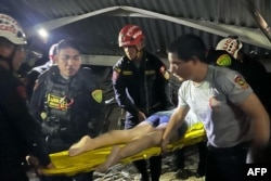 This handout picture released by La Libertad Police Region shows rescue teams working at the scene of an accident in which a roof of a food court collapsed in a shopping mall in Trujillo, Peru on February 21, 2025. (La Libertad Police Region/Handout AFP)