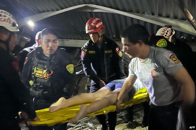This handout picture released by La Libertad Police Region shows rescue teams working at the scene of an accident in which a roof of a food court collapsed in a shopping mall in Trujillo, Peru on February 21, 2025. (La Libertad Police Region/Handout AFP)