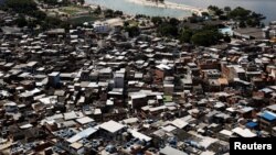 FILE - An artificial pond known as piscinao, or big pool, is seen next to the Mare slums complex, in the northern suburbs of Rio de Janeiro, Brazil, Jan. 15, 2017. 