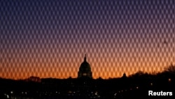 FILE - A security fence stands near the U.S. Capitol as the sun rises in Washington, Jan. 7, 2025.