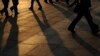 FILE - Pedestrians are seen walking across a plaza.