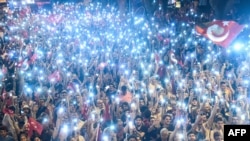 FILE - Supporters use flashlights on their cell-phones as they listen to presidential candidate of Turkey's main opposition Republican People's Party (CHP) Muharrem Ince (unseen) during an election campaign rally in Istanbul on June 9, 2018. 