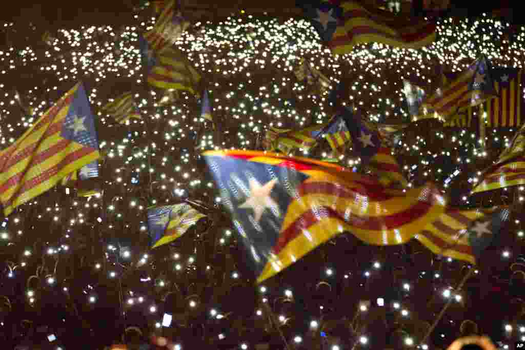 Pro-independence supporters wave &quot;estelada&quot; or pro-independence flags during a rally of &quot;Junts pel Si&quot; or &quot;Together for YES&quot; in Barcelona, Spain. Catalans vote Sunday in regional parliamentary elections that the breakaway camp hopes will give them a mandate to put their region on a path toward independence.