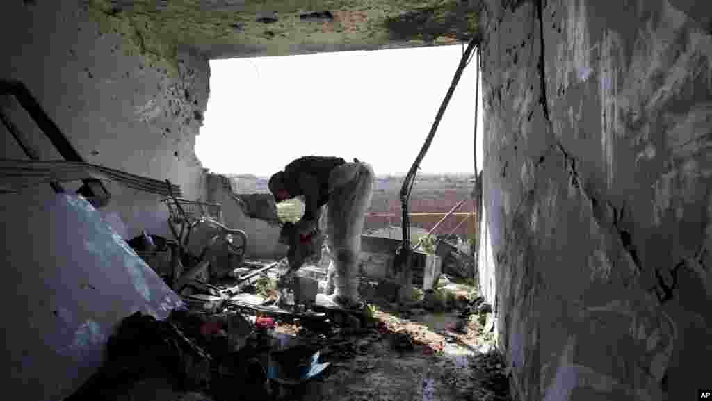 A Zaka volunteer cleans blood stains from an apartment in a building that was hit by a rocket fired from the Gaza Strip, where three people were killed in Kiryat Malachi, southern Israel, Kiryat Malachi, southern Israel, November 15, 2012.
