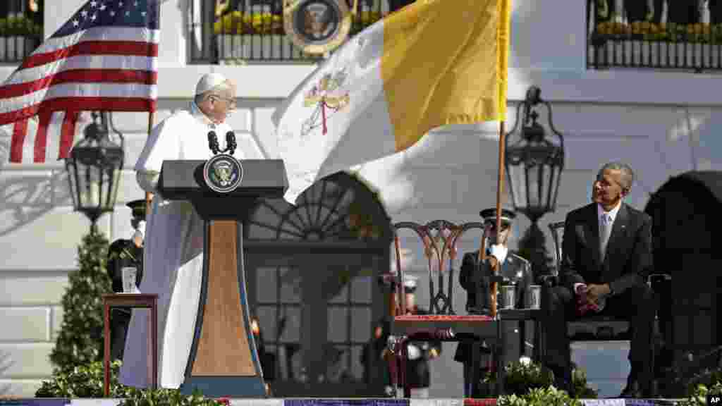 Pope Francis turns toward President Barack Obama during his welcoming remarks at the state arrival ceremony in his honor on the South Lawn of the White House, Sept. 23, 2015.