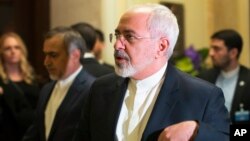 Iran's Foreign Minister Mohammad Javad Zarif walks into another negotiating meeting with United States Secretary of State John Kerry over Iran's nuclear program in Lausanne, Switzerland, March 18, 2015.