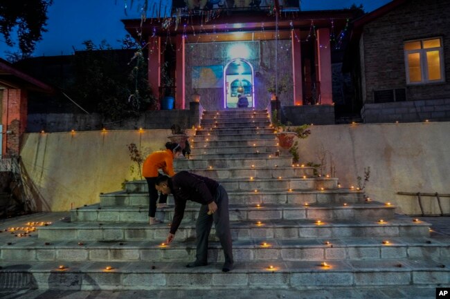 Hindus light candle outside the stairs of a temple as they celebrate Diwali, the Hindu festival of lights in Srinagar, Indian controlled Kashmir, Monday, Oct. 24, 2022. (AP Photo/Mukhtar Khan)