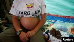 Revolutionary Armed Forces of Colombia's Tatiana, 36 and six months pregnant, sits next to gifts for the baby at a camp where the FARC will ratify a peace deal with the Colombian government, near El Diamante in Yari Plains, Colombia, Sept. 17, 2016.