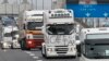 French truck drivers demonstrate against the Ecotax on the motorway outside Lyon, November 16, 2013. The government agreed last month to suspend introduction of the tax but rejected to scrap it altogether. REUTERS/Robert Pratta (FRANCE - Tags: BUSINESS 