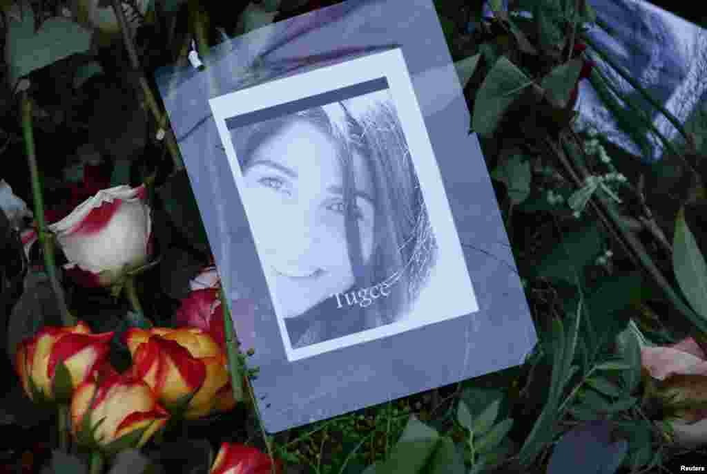 Lit candles and photographs of Tugce Albayrak are placed by her grave at a cemetery in Bad Soden-Salmuenster, Dec. 3, 2014.