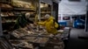 FILE - A woman buys from a vendor at a market in Kyiv, Ukraine, on Jan. 30, 2023. The U.S. Treasury Department on Dec. 10, 2024, transferred $20 billion to a World Bank fund, part of a larger loan to Ukraine for economic and financial aid.