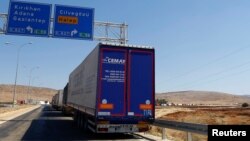 Commercial Turkish trucks wait to cross to Syria near the Cilvegozu border gate, located opposite the Syrian commercial crossing point Bab al-Hawa in Reyhanli, Hatay province, Turkey, Sept. 16, 2016. 