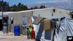 Anak-anak pengungsi Suriah berdiri di dekat tenda keluarga mereka di kamp pengungsi Suriah di kota Bar Elias, Bukit Bekaa, Lebanon, 23 April 2018. 