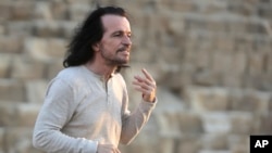 Greek musician Yiannis Hrysomallis, who goes by the stage name Yanni, poses during his visit to the Giza Pyramids, just outside Cairo, Egypt, Oct. 28, 2015.