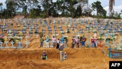 This aerial photo shows a burial at an area where new graves have been dug at the Nossa Senhora Aparecida cemetery in Manaus in the Amazon forest in Brazil, on April 22, 2020.