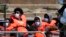 FILE - People thought to be migrants who made the crossing from France are brought into port after being picked up in the Channel by a British border force vessel in Dover, south east England, Thursday, July 22, 2021.