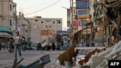 FILE - Damage caused by regime airstrikes is seen in the rebel-held town of Nawa, about 30 kilometers north of Daraa in southern Syria, July 17, 2018.