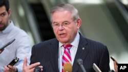 FILE - Democratic Sen. Bob Menendez speaks with the media on Capitol Hill in Washington, March 5, 2019.