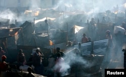 People displaced during post-election violence are seen in a temporary shelter in Burnt Forest, Kenya, Jan. 6, 2008.