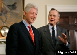 FILE - Former President Bill Clinton laughs as he and former President George H.W. Bush answer questions about their tour of the Asian tsunami region, March 8, 2005, in the White House.