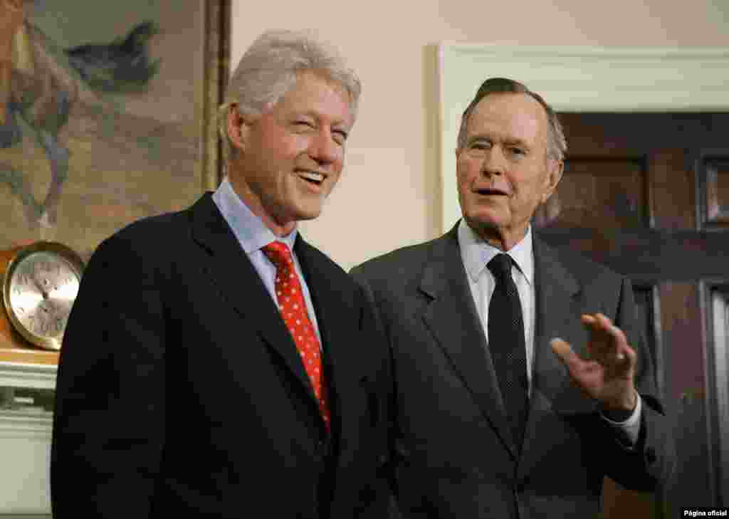FILE - Former President Bill Clinton laughs as he and former President George H.W. Bush answer questions about their tour of the Asian tsunami region, March 8, 2005, in the White House.