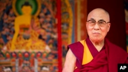 FILE - Tibet's exiled government and Buddhist spiritual leader, the Dalai Lama, on stage before making a speech at the ESS Stadium in Aldershot, southern England, June 29, 2015.