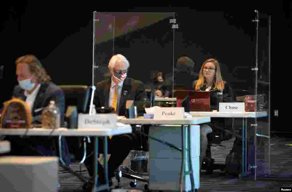 Virginia state Senator Amanda Chase, a Republican who refuses to wear a mask, sits inside a plexiglass booth erected for her against the spread of COVID-19 during the Senate special session at the Science Museum of Virginia remote location in Richmond.