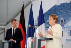 German Chancellor Angela Merkel and French President Emmanuel Macron give a joint press conference after a bilateral meeting at Meseberg Castle, in Meseberg, Germany, June 29, 2020.