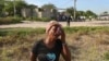 A woman cries during the funeral of a neighbor who was killed during an attack by armed gangs in Pont-Sonde, Haiti, on Oct. 8, 2024. The second-in-command of one of Haiti's most powerful gangs was injured in a police shootout, authorities said on Oct. 15, 2024.