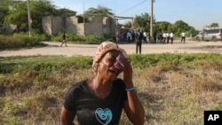 A woman cries during the funeral of a neighbor who was killed during an attack by armed gangs in Pont-Sonde, Haiti, on Oct. 8, 2024. The second-in-command of one of Haiti's most powerful gangs was injured in a police shootout, authorities said on Oct. 15, 2024.