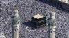 Muslim pilgrims moving around the Kaaba, the black cube seen at center, inside the Grand Mosque, during the annual Hajj in the Saudi holy city of Mecca, Saudi Arabia, November 7, 2011.