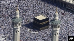 Muslim pilgrims moving around the Kaaba, the black cube seen at center, inside the Grand Mosque, during the annual Hajj in the Saudi holy city of Mecca, Saudi Arabia, November 7, 2011.