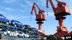 FILE - Cars to be exported are seen at a port in Lianyungang in China's eastern Jiangsu province on May 31, 2018.