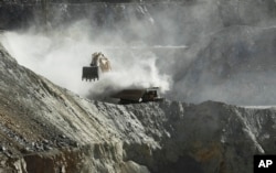 In this Sept. 25, 2012 photo, a bulldozer works at the Chuquicamata copper mine in the Atacama desert in northern Chile.